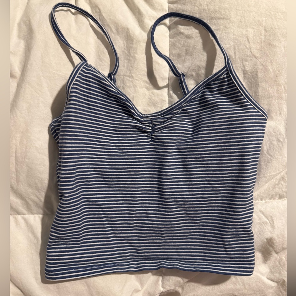 Out from under navy blue tank top